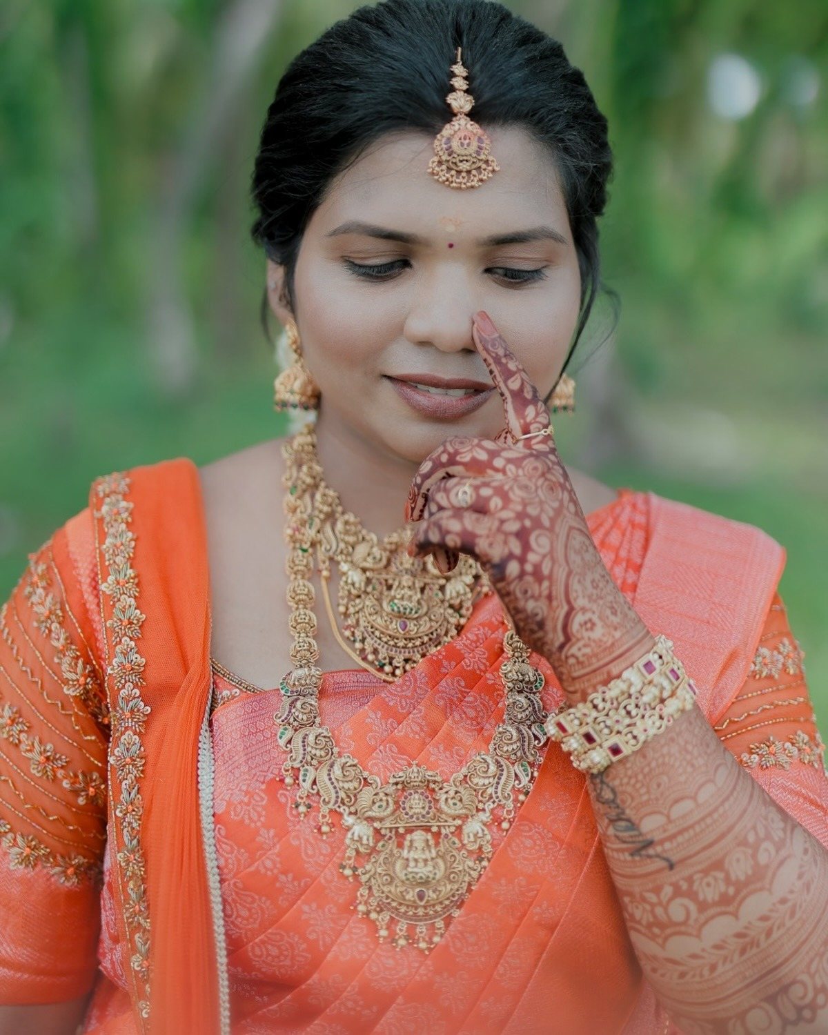 Bride in orange kasavu saree