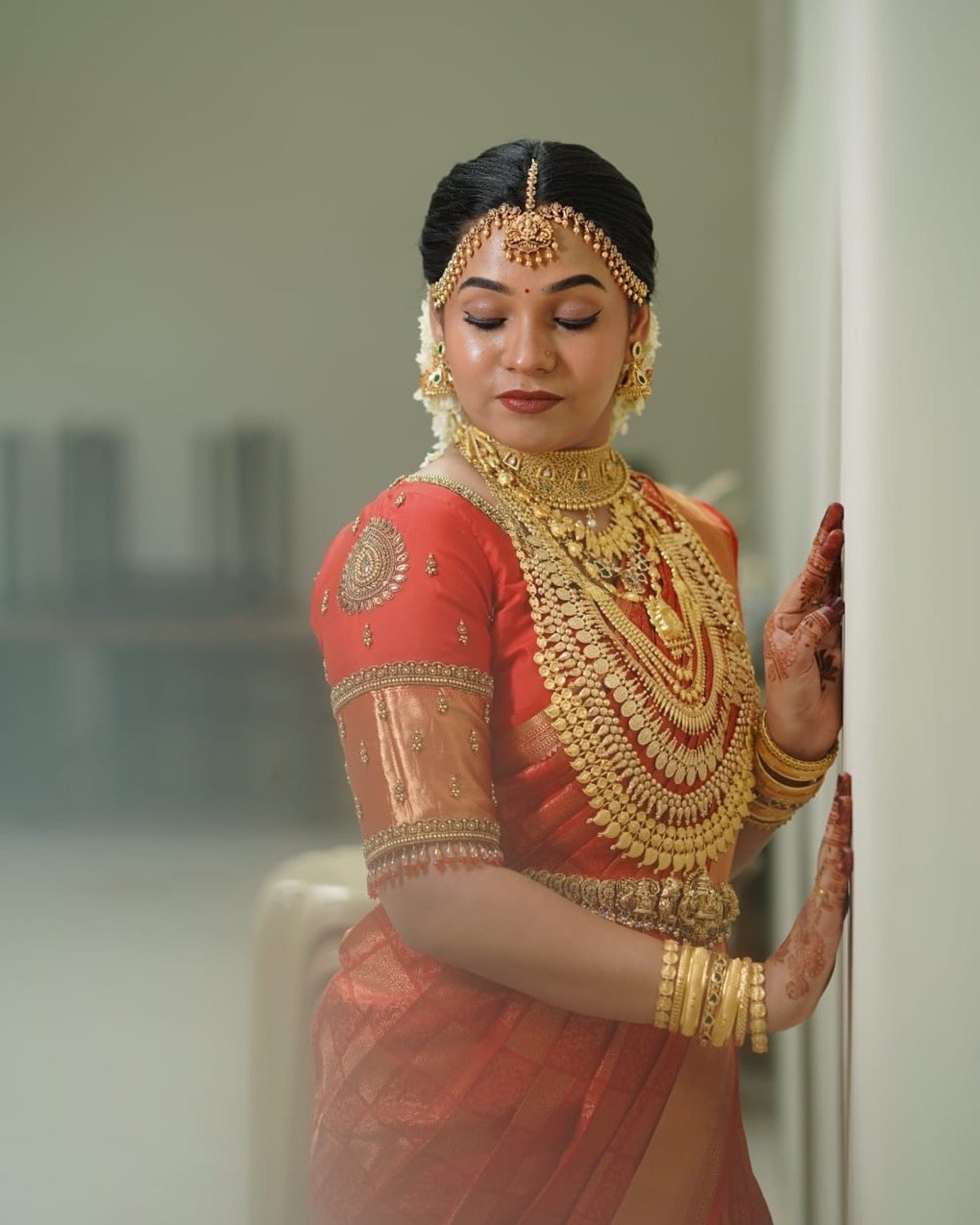 Bride in red and gold kasavu silk